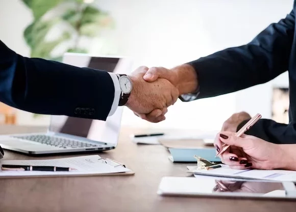 Handshake over an office table